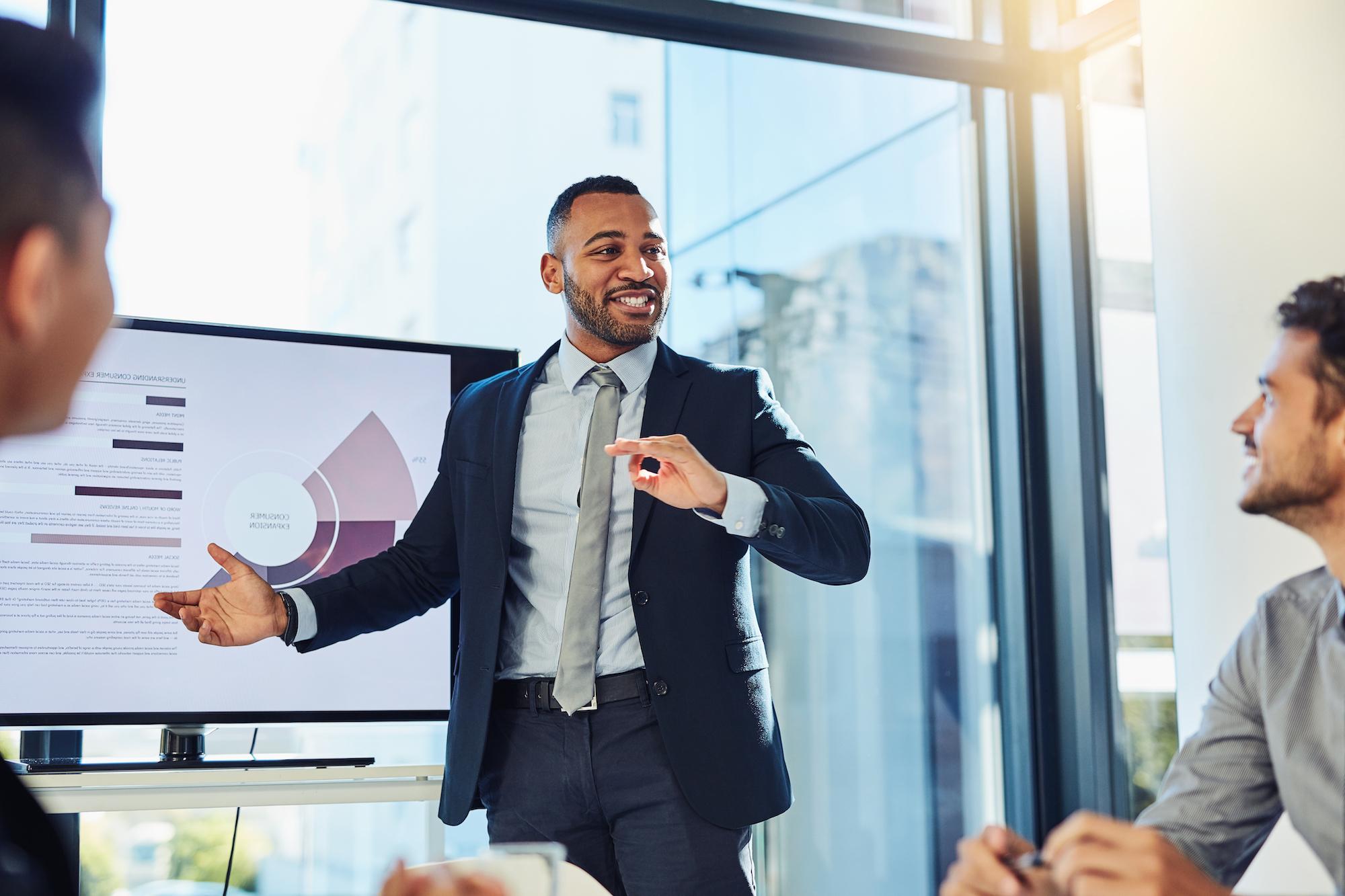 man presenting data on screen