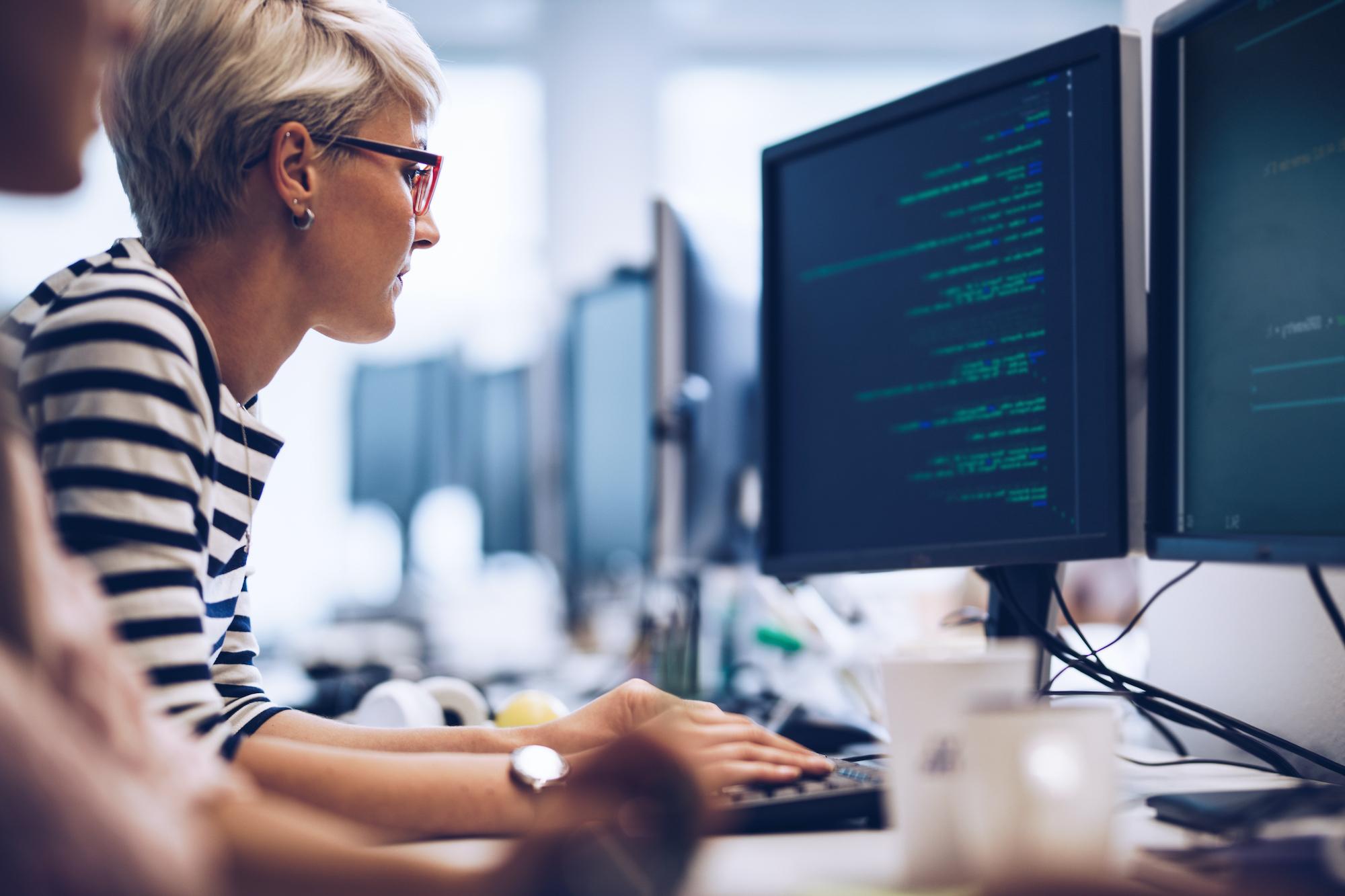 woman analyzing data on computer screen